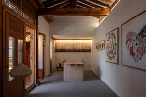 A minimalist interior featuring wooden furniture and decor, with a focus on natural light and clean lines.
