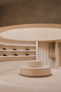 A minimalist shoe closet featuring concrete and wood materials.