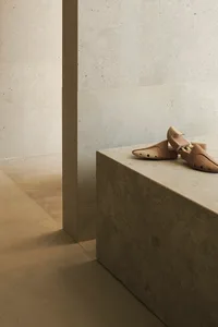 Shoe making space with minimalist design and concrete materials.