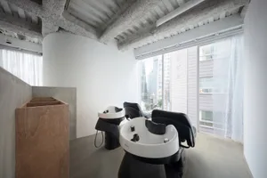 Modern interior of a hair salon with concrete and wood materials