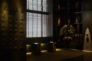 A modern lobby interior featuring a metal-clad ceiling and art installation.