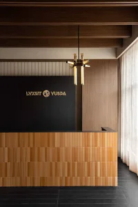 Modern lobby reception area with tiles and concrete walls.