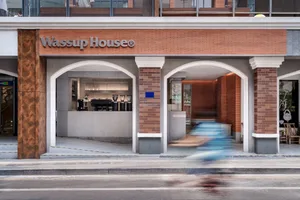 A modern retail coffee shop's entryway with brick and concrete materials