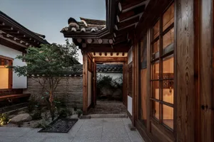 Traditional wooden interior of a Korean home, featuring tiled flooring and traditional roofing tiles.
