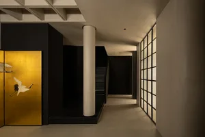A modern interior designed with black and white elements, featuring concrete floors, white glass walls, and black fixtures.