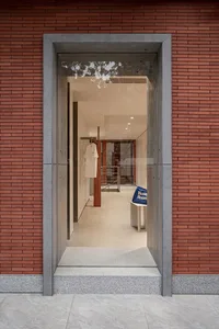 Exterior view of a modern retail storefront featuring brick walls and large glass windows.