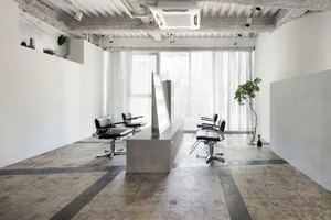 Modern salon interior with grey concrete and glass design elements