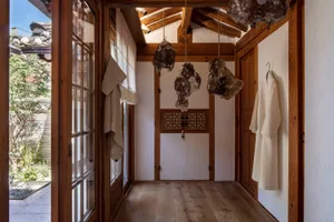 A traditional wooden kitchen interior featuring natural stones and a rustic atmosphere.