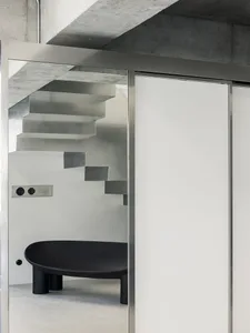 Modern interior with concrete stairs and steel furniture
