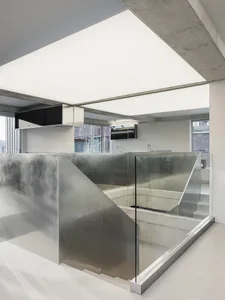 An interior office space featuring modern, minimalist design with concrete elements.
