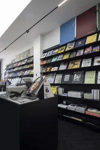 A modern bookstore with black shelves filled with books.