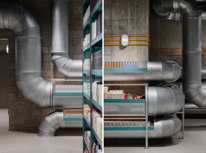 A modern industrial storefront with metallic pipes and concrete walls.