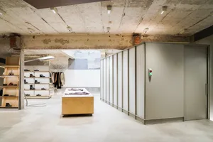 Industrial retail showroom with concrete walls and floor, minimalist design