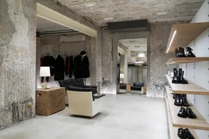 Modern retail showroom with concrete walls and an aluminum ceiling.