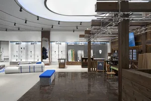 Retail storefront featuring industrial design elements with concrete and wood materials.