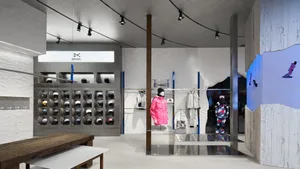 A modern retail storefront featuring industrial design elements with metal shelving and concrete surfaces.