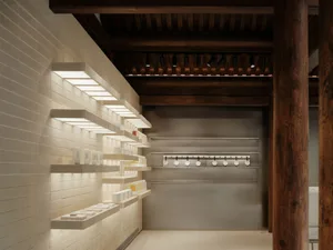 A minimalist interior space featuring light concrete walls and modern design elements.