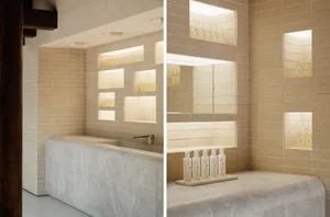 Spa interior with minimalist design featuring marble elements and stone walls.