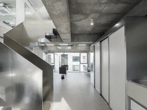 Modern minimalist office interior featuring concrete walls and floors.