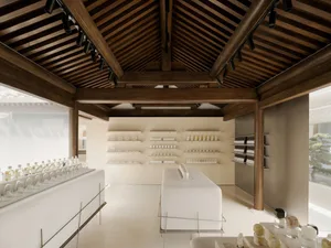 A minimalist retail storefront featuring white walls with concrete and wood accents.