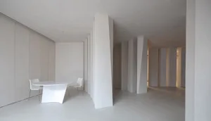 Modern dining room with minimalist design and concrete table and chairs.