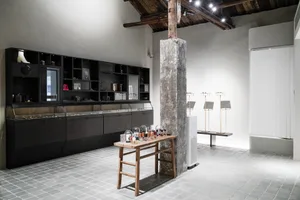 A modern exhibition space with concrete and wooden elements