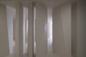 A minimalist interior featuring modern, tall, concrete columns.