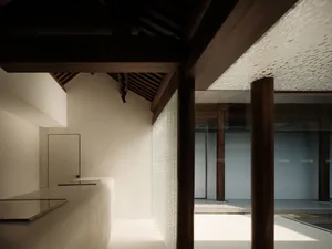 Modern interior design featuring glass windows and concrete walls