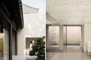 Modern interior space with glass walls and concrete floor.