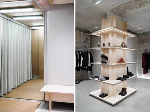 A modern retail space featuring a plywood display structure with illuminated shelves and racks.