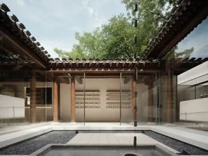 A modern retail storefront featuring concrete walls, glass walls, and wooden beams.