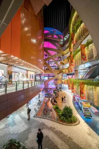 A vibrant shopping center interior with metal-clad walls and a mix of materials.