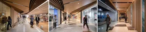 A modern shopping mall interior featuring timber materials and contemporary design elements.