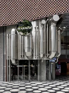 Urban storefront with modern, industrial design featuring metal and glass elements.