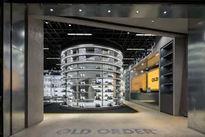 A minimalist retail space with metal, steel, and glass displays.