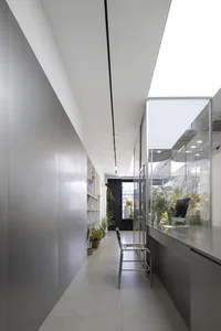 Modern office space featuring glass walls, metal accents, and concrete flooring.