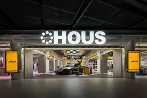 Modern retail storefront with black steel and yellow accents