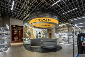 Industrial-themed retail store with concrete and glass materials, featuring metallic accents and a minimalist design.