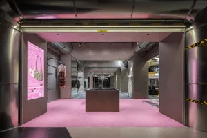 Modern, industrial storefront with metallic exterior and pink carpeting