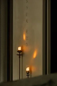 A minimalist interior design featuring candle lighting, creating a cozy atmosphere.