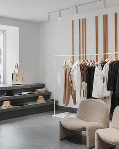 A minimalist retail store featuring neutral materials and a clean, organized design.