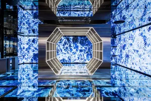 A modern commercial space featuring blue stone and metallic elements.