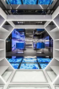 Modern retail store featuring glass flooring and blue lighting