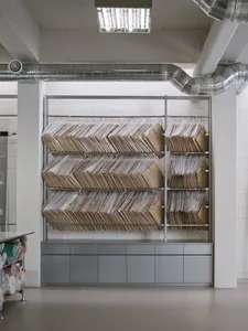 Large industrial storage rack filled with cardboard boxes in a warehouse setting.
