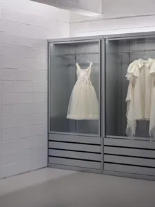 Modern, minimalist clothing display cabinets made of glass.