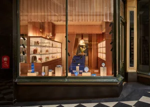 A glass display case inside a modern retail storefront showcasing jewelry and decorative items.
