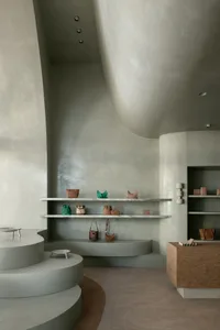 A modern retail store with minimalist design and concrete architectural elements.