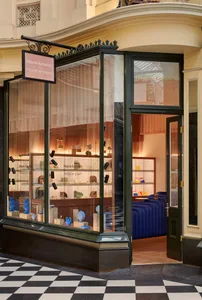 Modern retail storefront with glass windows displaying jewelry.