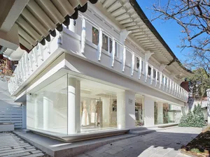 Modern retail storefront with large glass windows and stone facade