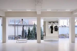 A modern retail space featuring clear glass elements and a minimalist design.